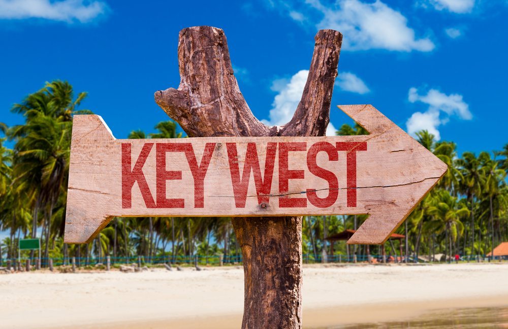 Key West written on wooden sign in shape of arrow.