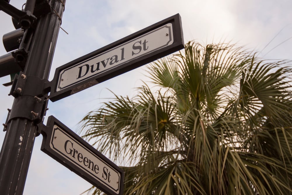 Duval Street and Greene street signs on light pole.