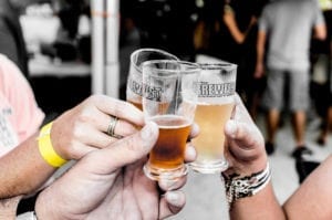 Three people toasting with beer glasses.