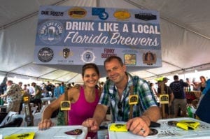 Two people at brew fest booth.