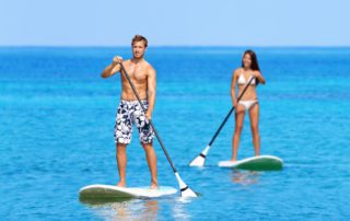 A photo of a couple paddleboarding in Key West.